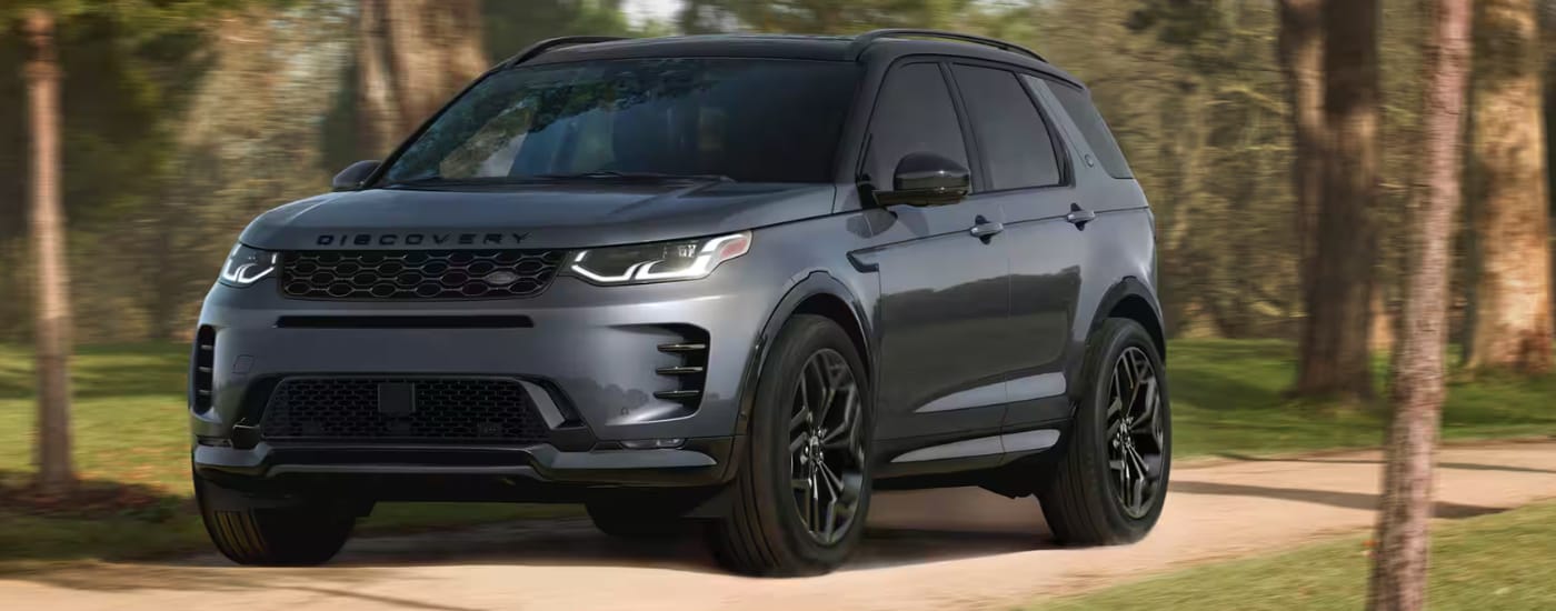 A gray 2026 Land Rover Discovery Sport parked off-road