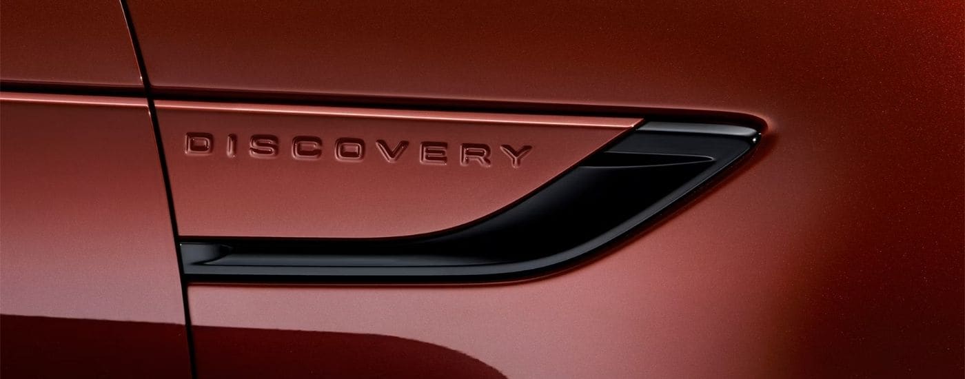 Side of a red 2026 Land Rover Discovery