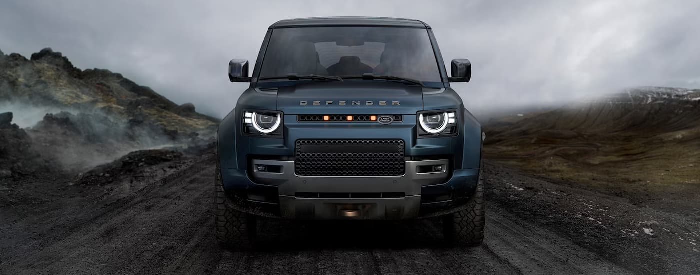 Green 2026 Land Rover Defender OCTA driving off-road.