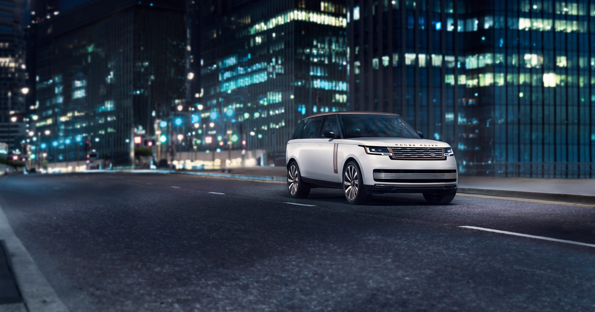 Range Rover driving in the city at night