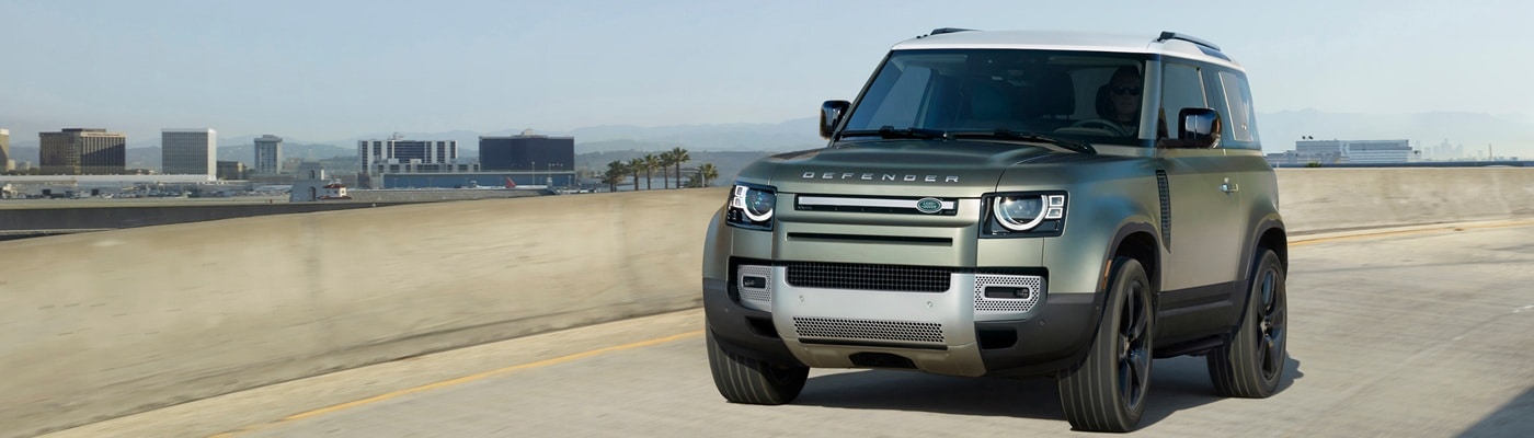 Defender 90 Defender 90 driving on a city overpass in the day