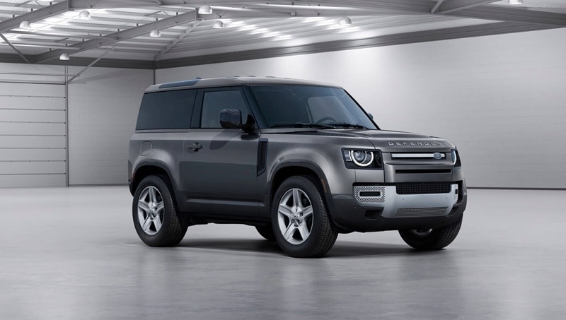 Defender driving on a hillside road
