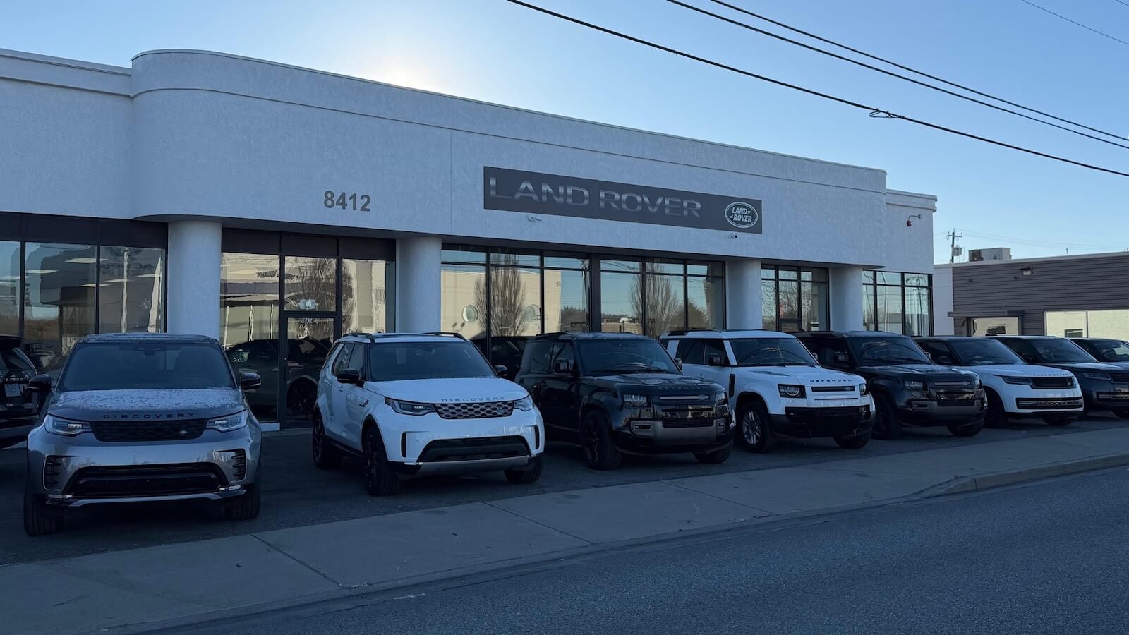 Exterior view of Land Rover Spokane with new Range Rover and Defender models sitting out front
