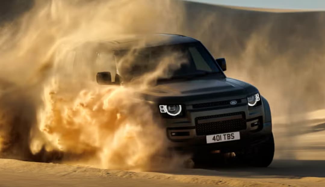 LR%20SUV%20driving%20through%20sand%20dunes.png