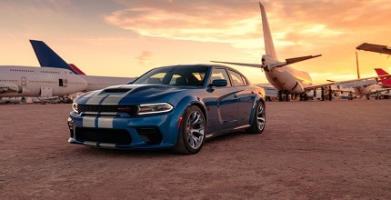 Dodge Charger near airplanes