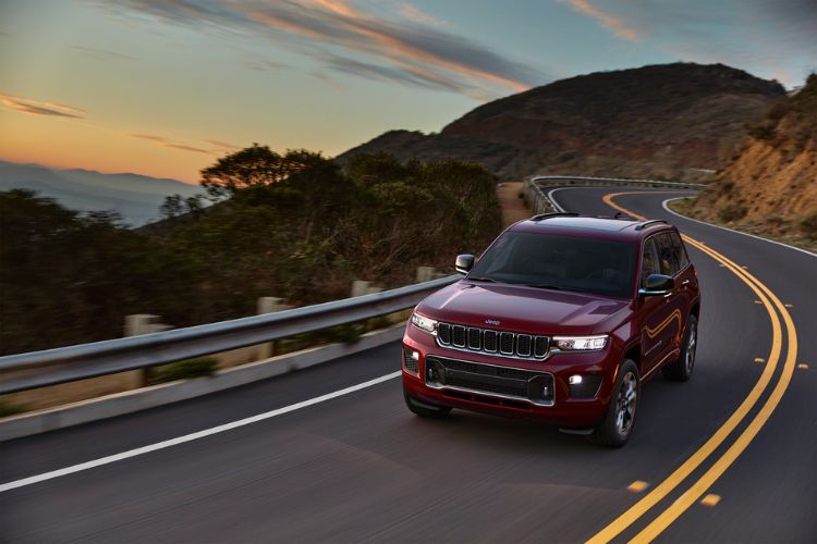 Jeep Grand Cherokee Jeep Grand Cherokee driving towards camera with headlights on