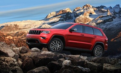 red Jeep Grand Cherokee Trailhawk off-roading