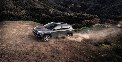 Jeep Compass driving up a steep hill