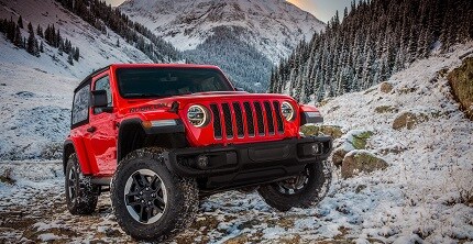 red jeep wrangler suv in the snow