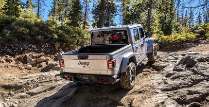 Jeep Gladiator on rocky forest path