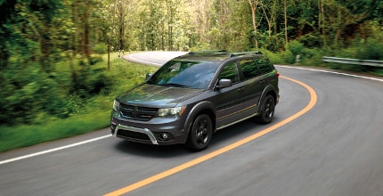 Dodge Journey driving on forest road
