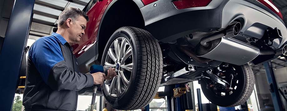 Ford service technician performing tire and brake service at Lasco Ford in Fenton Michigan