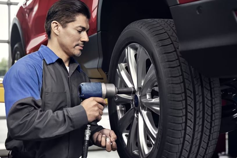 Ford certified technician inspecting pre-owned vehicle at Lasco Ford