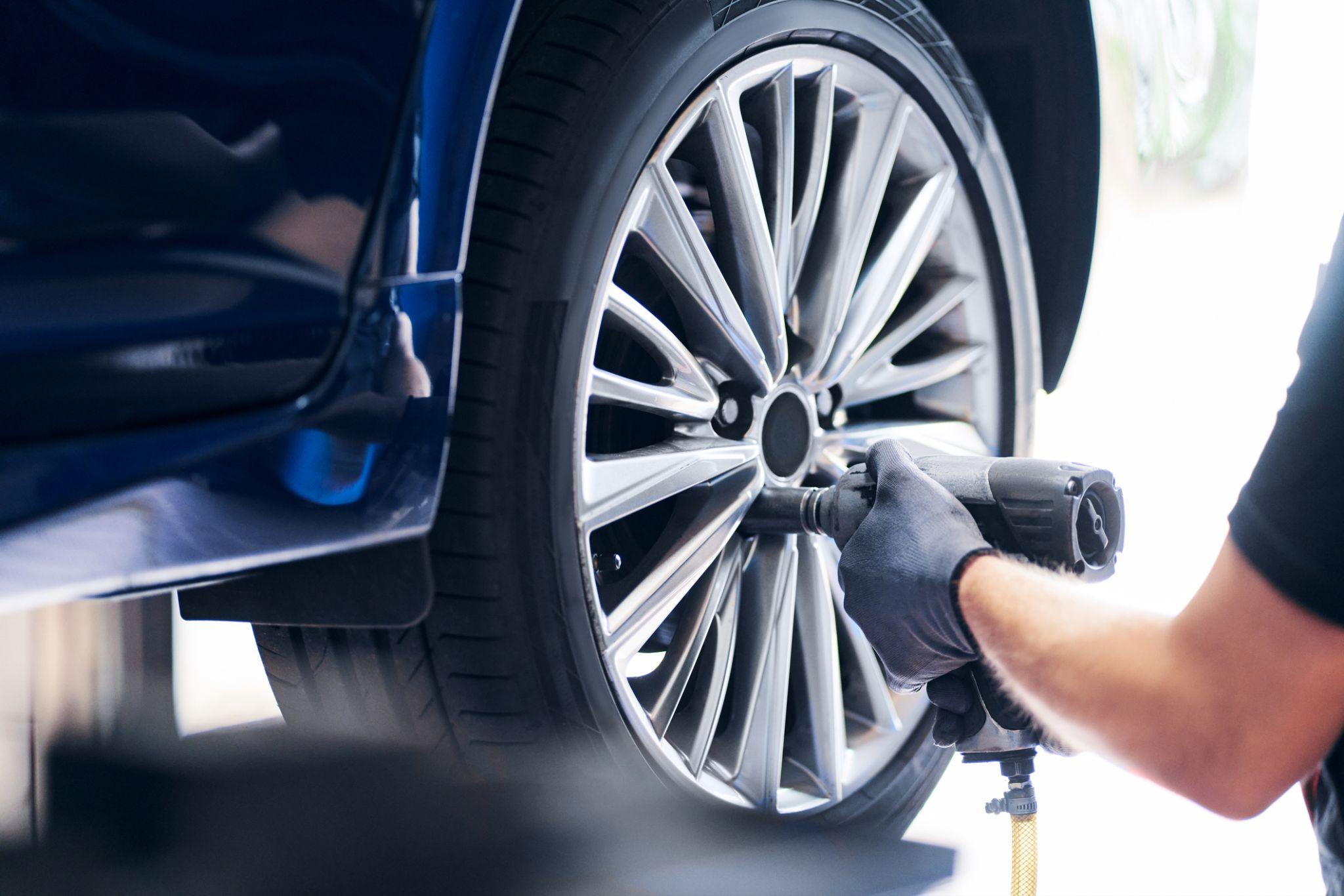 A technician replaces a tire on a vehicle.