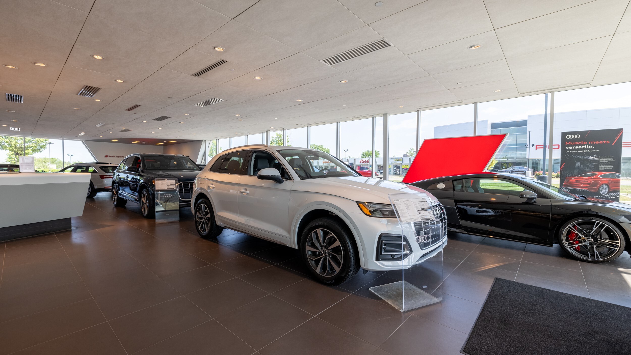 Autonation Audi interior with white Audi car parked inside