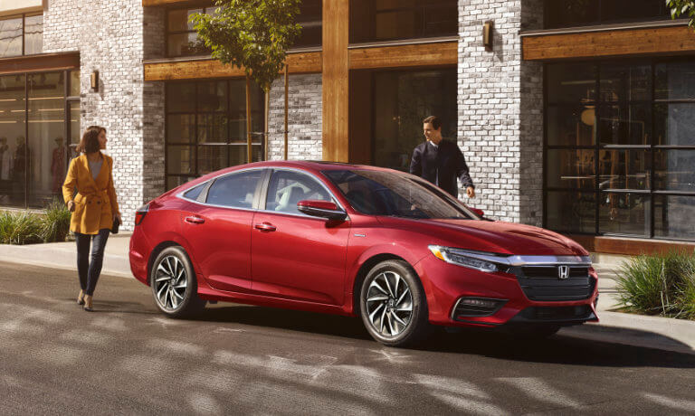 2022 Honda Insight exterior with a young couple walking to the vehicle