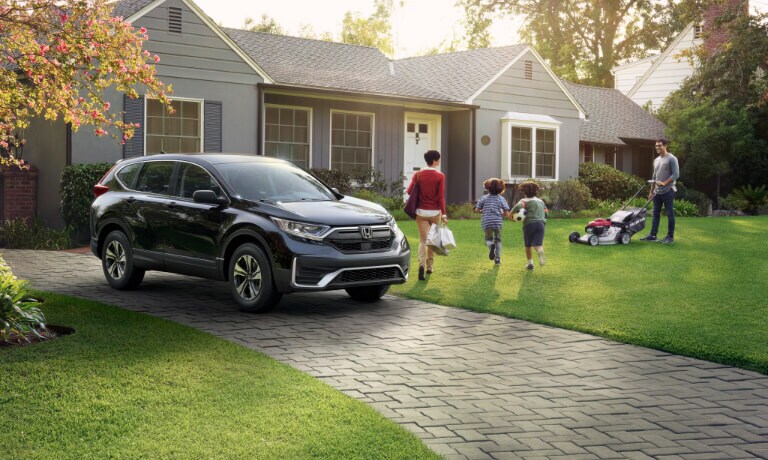 2022 Honda CR-V Exterior parked in a driveway with a family