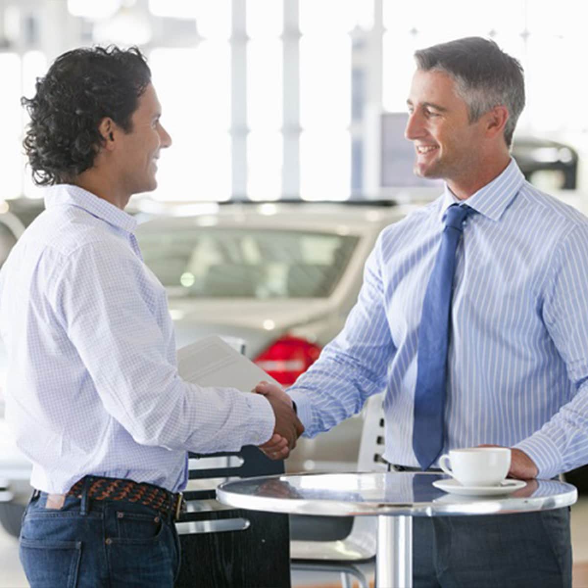 Dodge Sales Representative shaking hands with customer after a successful purchase
