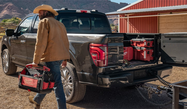Working man taking tool bag out from his 2026 Ford F-150 Truck Bed