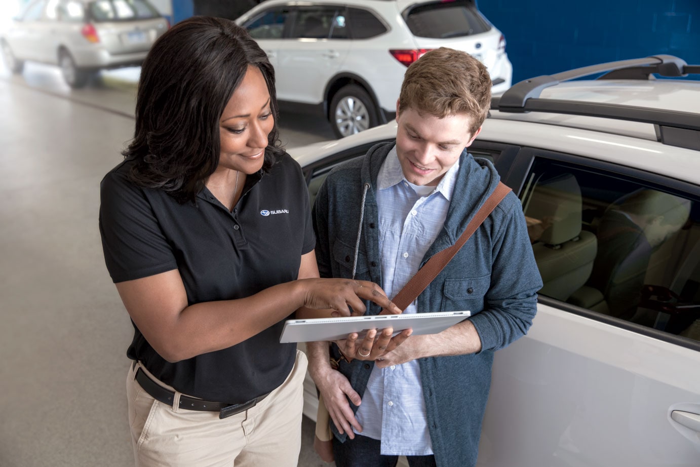 Subaru Representative explaining Certified Pre-Owned program benefits to customer