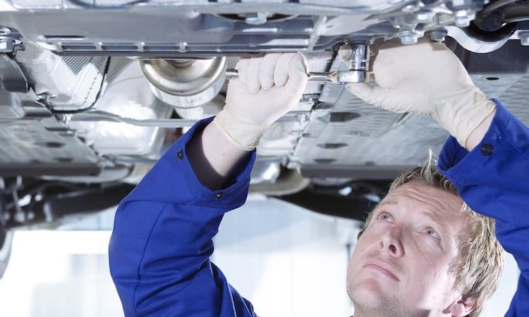 Mechanic working underneath a vehicle
