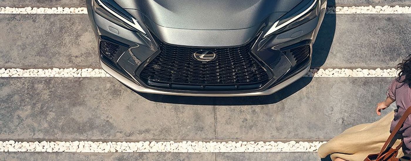 The front and hood of a grey 2024 Lexus NX Plug-In Hybrid is shown from above. 