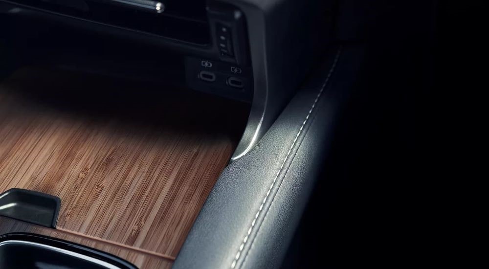 A close up shows the leather, stitching, and woodgrain in a 2023 Lexus RX.