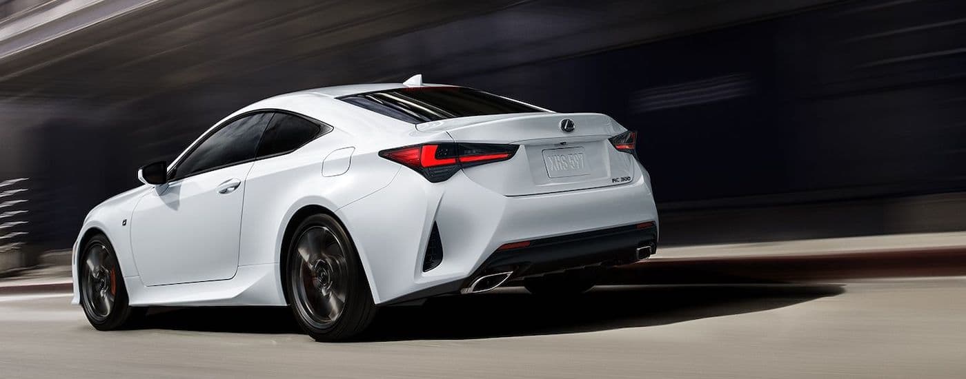 A white 2023 Lexus RC 300 F Sport is shown from the rear at an angle after leaving a used Lexus dealer.