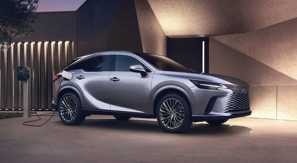 A silver Lexus RX is shown charging at a Lexus dealer near Great Neck.