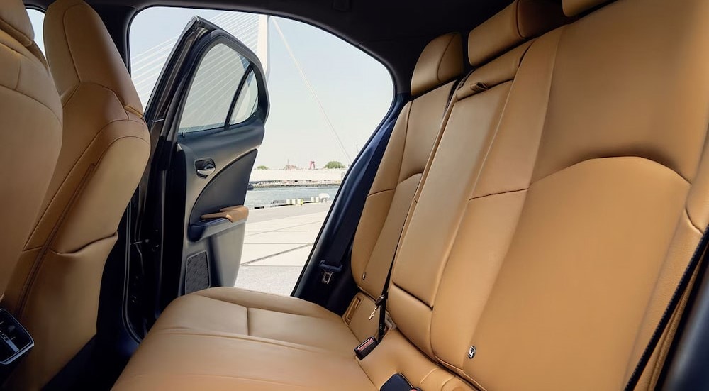 The tan rear interior in a 2024 Lexus UX 250h is shown.