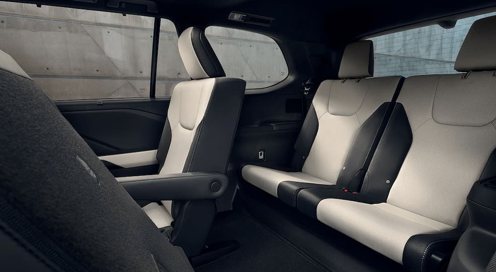 The black and white interior of a 2024 Lexus TX shows the rear seating area.