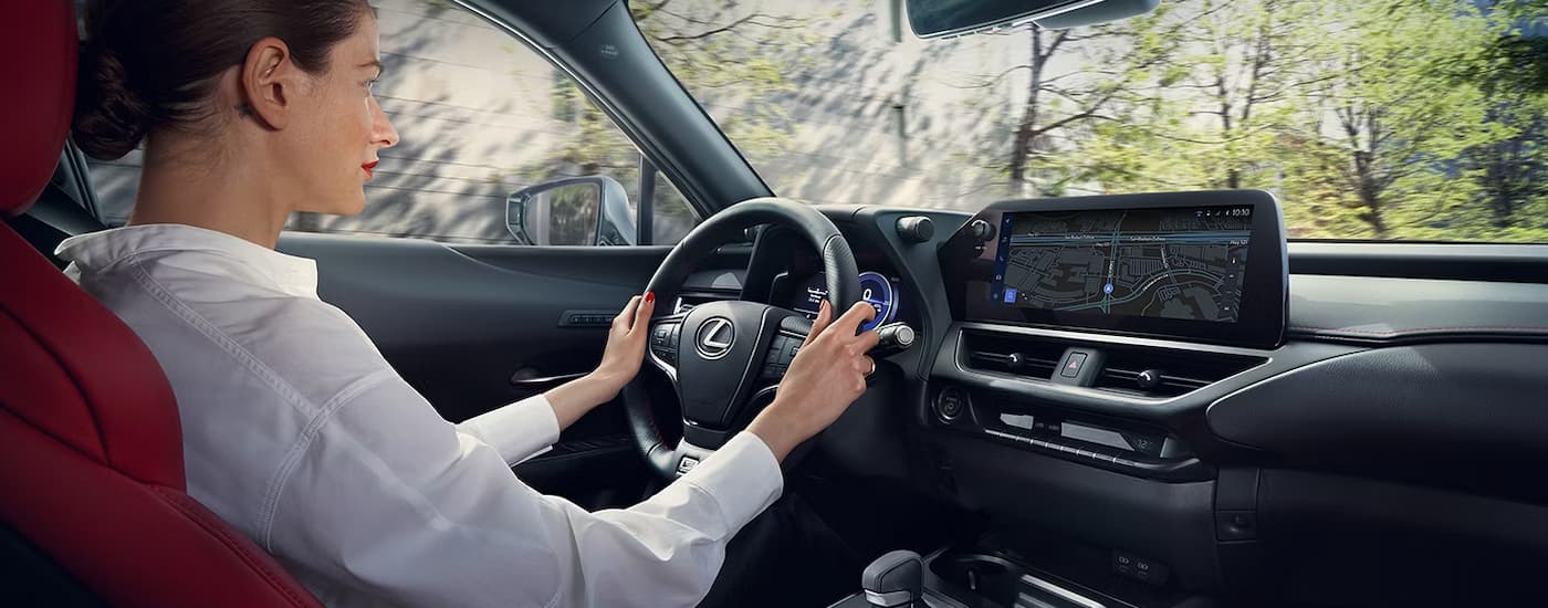 A person is driving in a 2024 Lexus UX Hybrid.