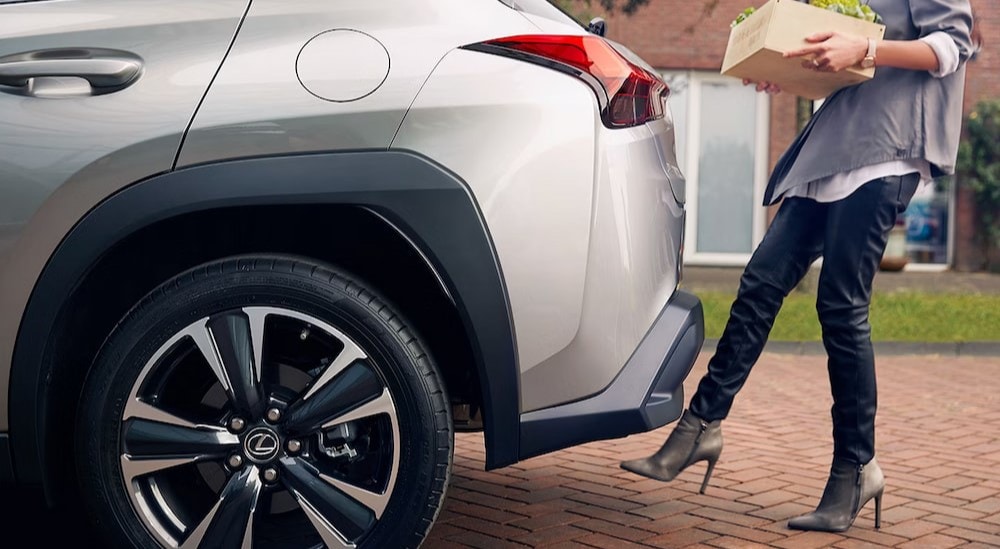 A close-up of the rear end on a white 2025 Lexus UX Hybrid is shown.