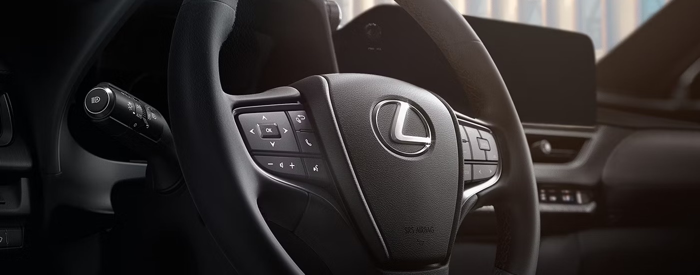 Close-up of the steering wheel in a 2025 Lexus US Hybrid for sale.