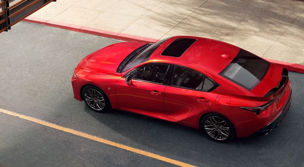 2024%20Lexus%20IS%20-%20Red.jpg A red 2024 Lexus IS is shown driving to a Lexus dealer near Brooklyn.