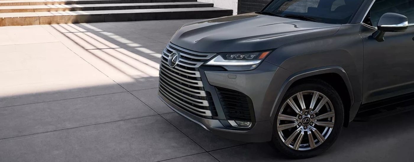A close-up on the hood and grille of a black 2024 Lexus LX.