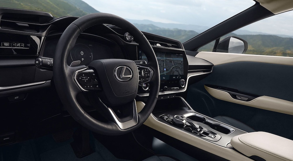 The steering wheel and dashboard in a 2024 Lexus RZ for sale.