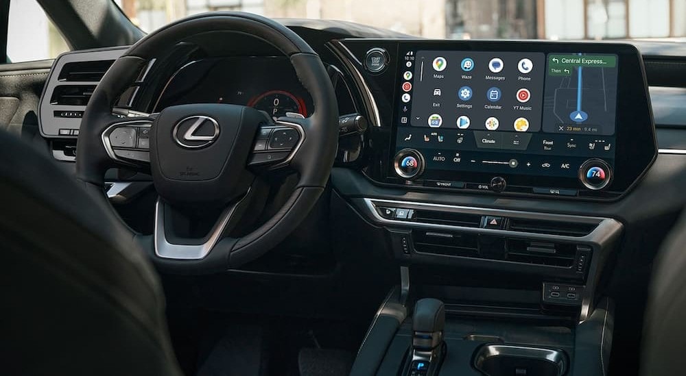 The black interior and dash of a 2024 Lexus RX is shown.