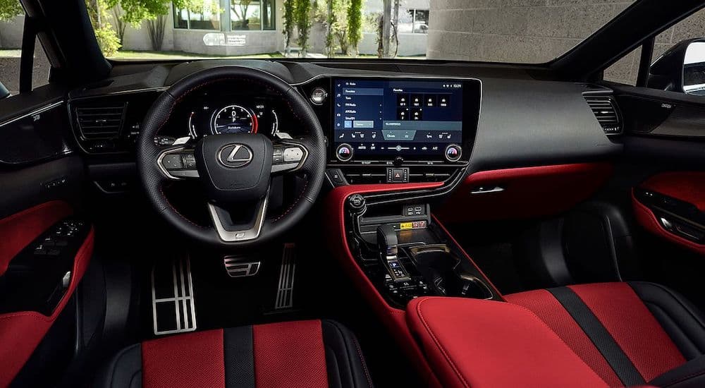 The red interior of a 2024 Lexus NX 350 F Sport is shown from the driver's seat.