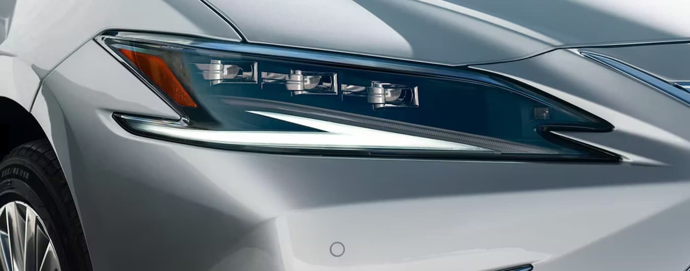 A close up of the headlight on a 2023 Lexus EX is shown at a Lexus dealer in New York City.