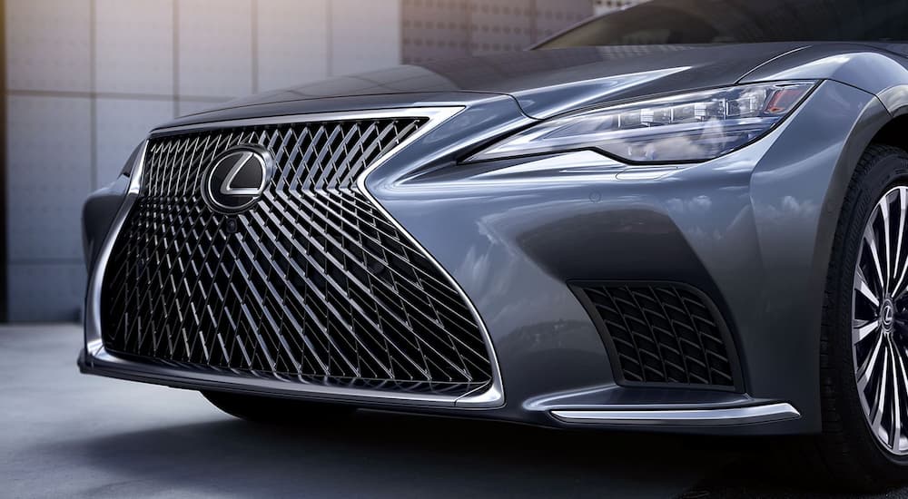 A close-up of the grille on a gray 2024 Lexus LS is shown.
