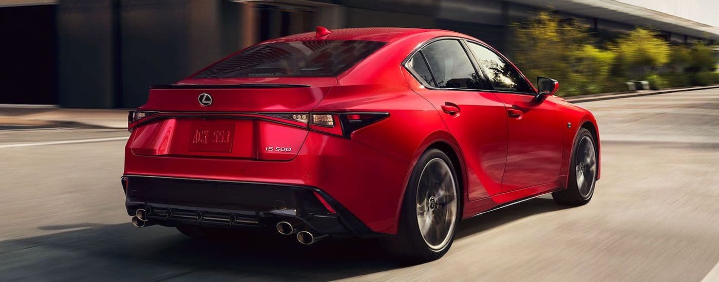A red 2023 Lexus IS 500 F Sport is shown from the rear at an angle.