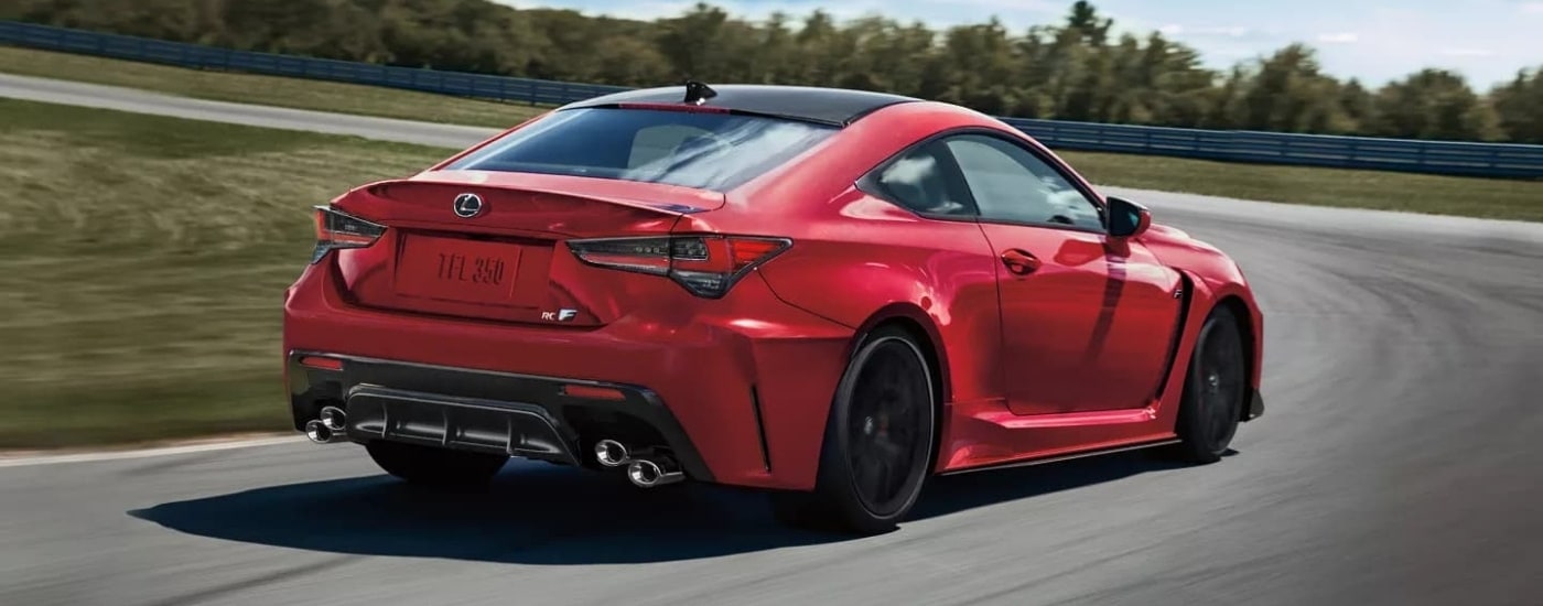 Red 2023 Lexus RC F rounding a corner on a race track