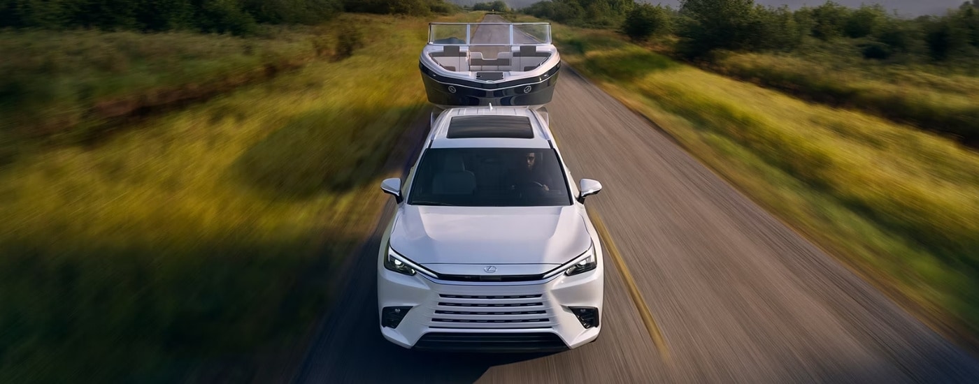 White 2026 Lexus TX towing a boat to a Lexus dealer near Springfield