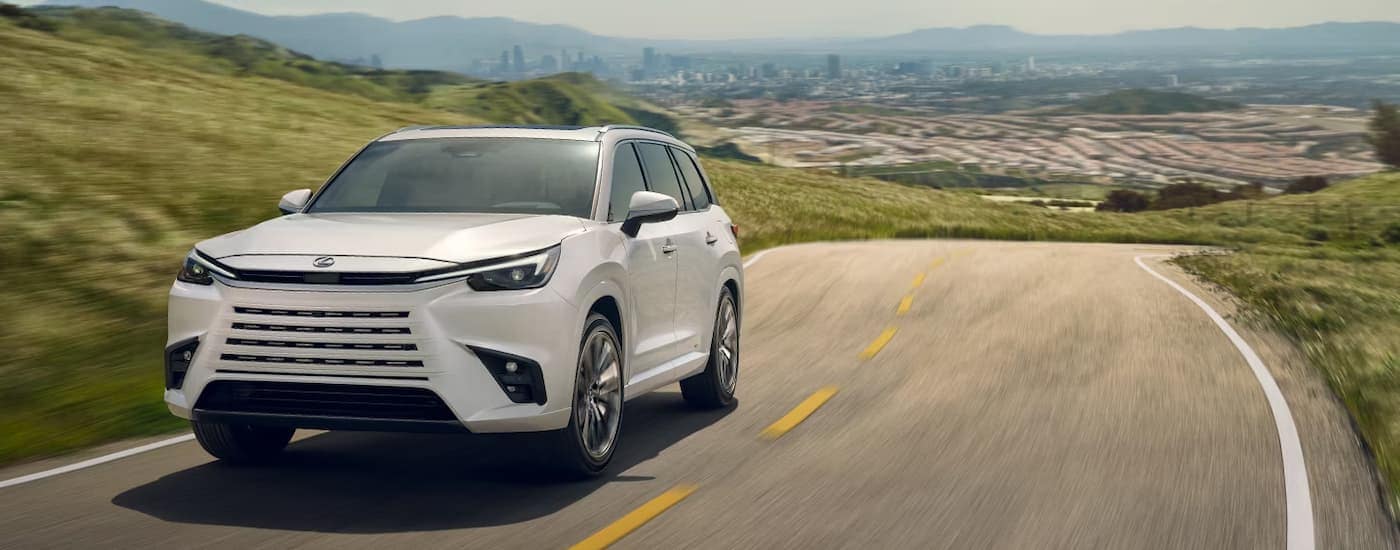 White 2026 Lexus TX driving on an open road