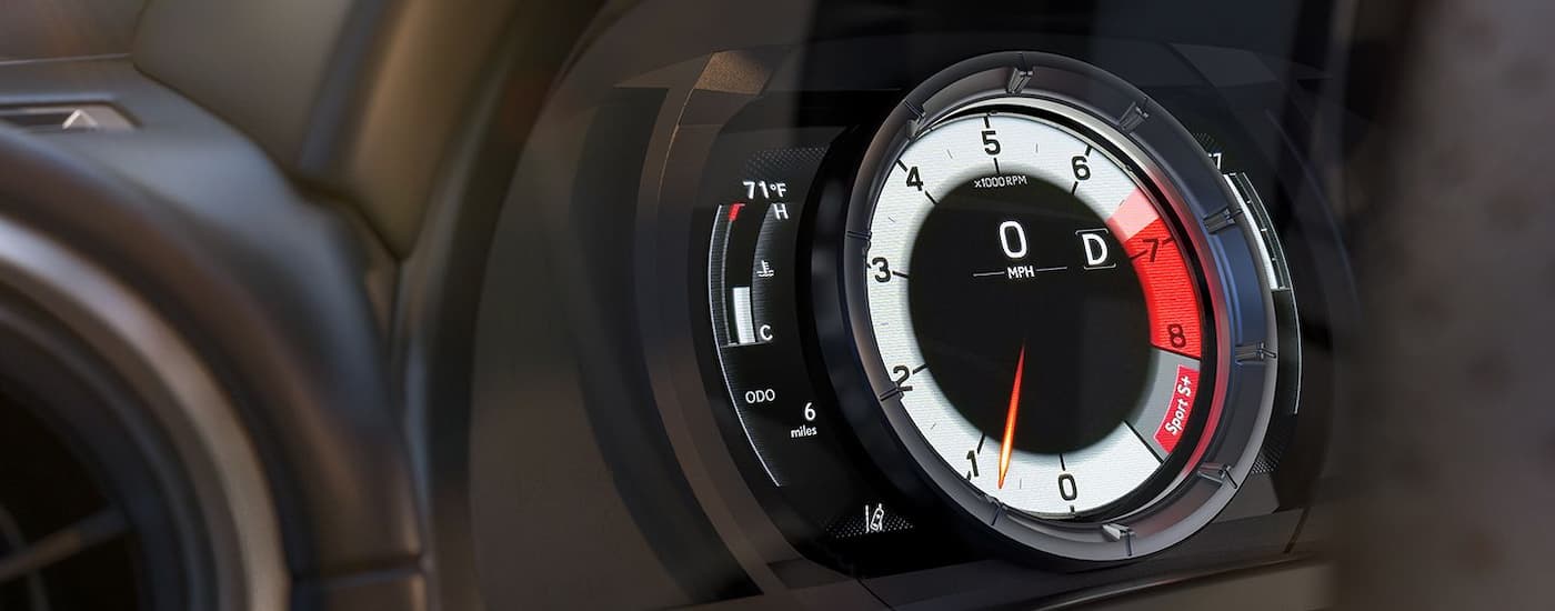 A close up of the dashboard cluster on a 2024 Lexus IS is shown.