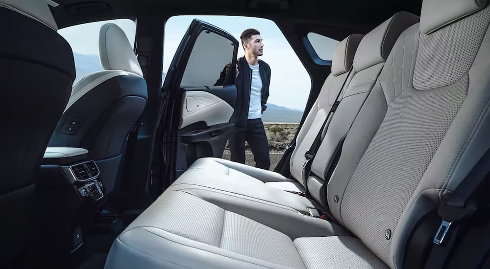 The black and grey interior of a 2023 Lexus RX 350 shows the rear seating.