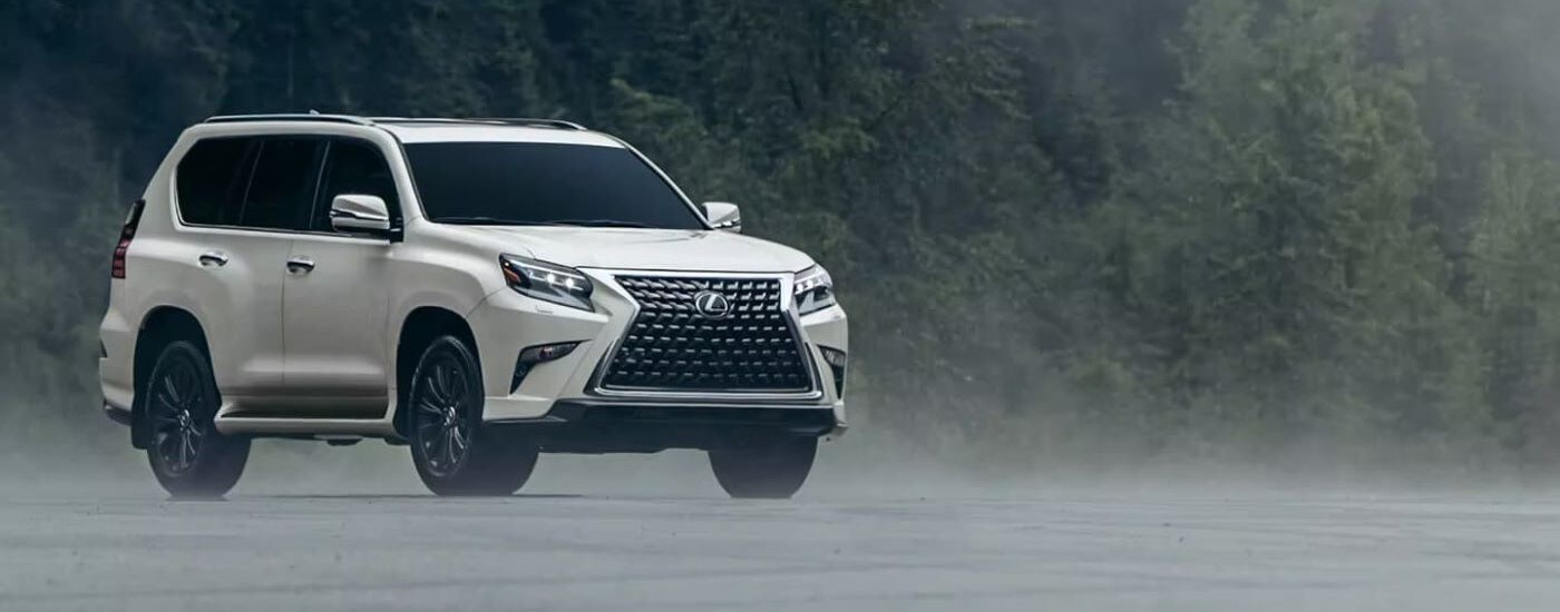 A white 2023 Lexus GX is shown from the front at an angle.