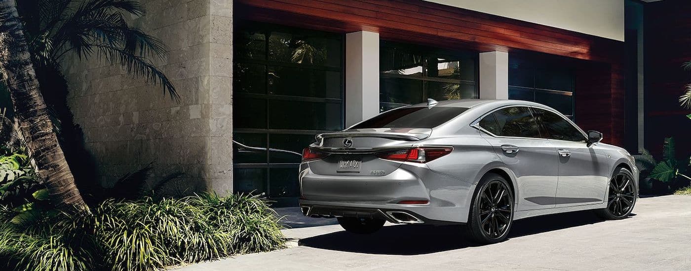 A silver 2023 Lexus ES is shown from the rear at an angle after leaving a used Lexus dealership.