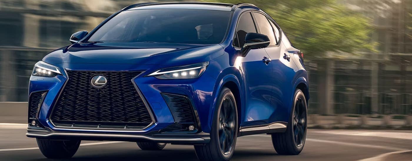 A blue 2024 Lexus NX is shown driving on a city street after checking out a Lexus Dealer in Long Island City.